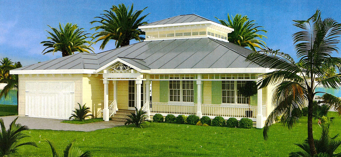 Single-story yellow house with a metal roof, front porch, attached garage, and palm trees in the yard.